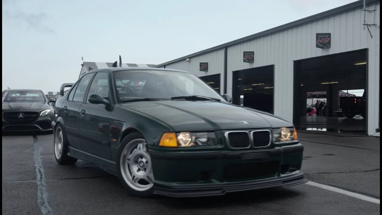 Green BMW E36 M3 sedan with S85 V10 swap at Mpact