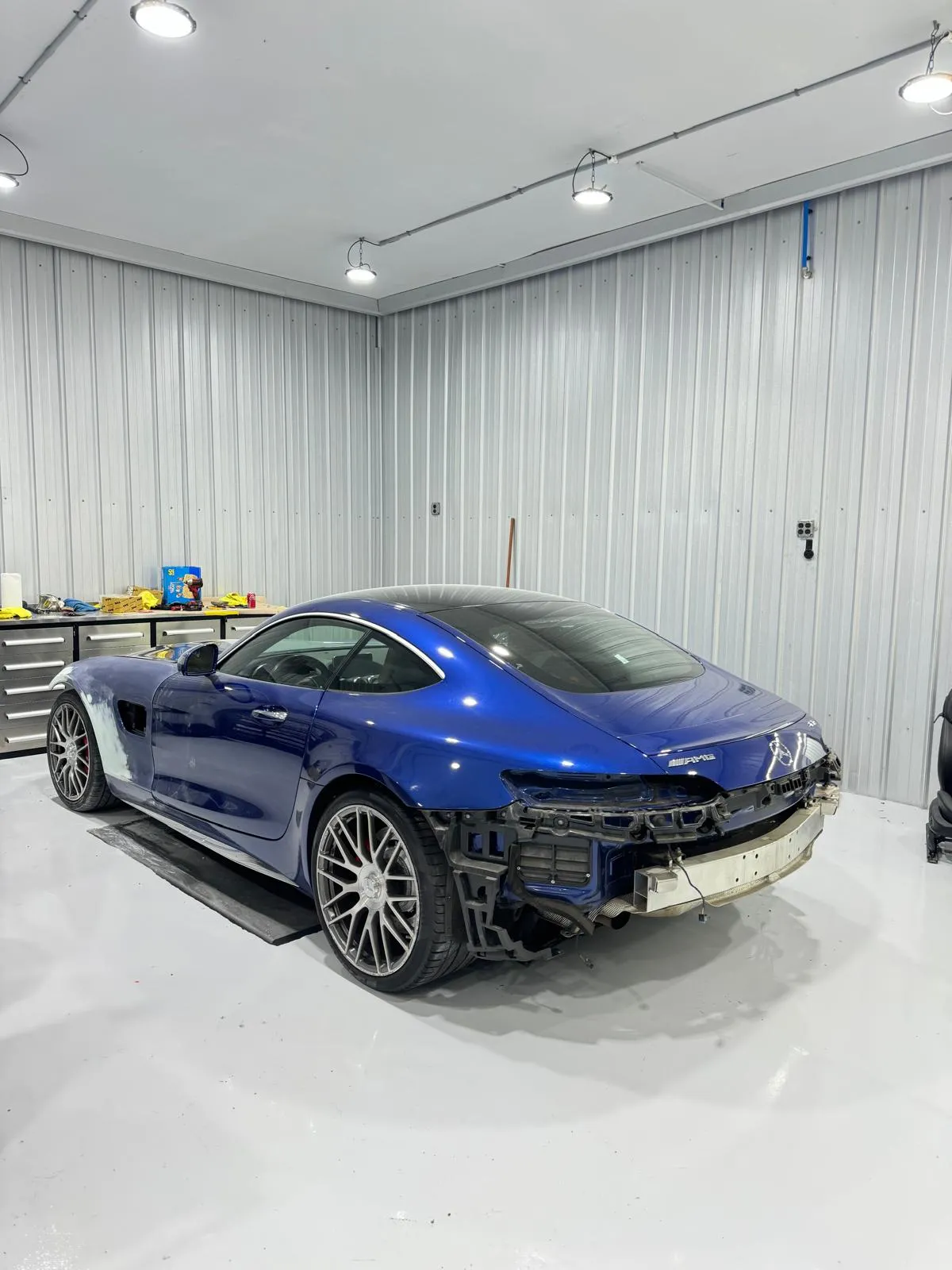 Rear bumper and quarter panel collision repair on an AMG GT. Aluminum structural work and full refinish.