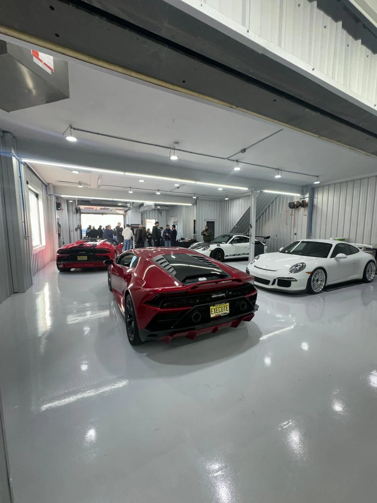 Red Huracan and white 991 GT3 in the shop. Exotic service and paint correction.