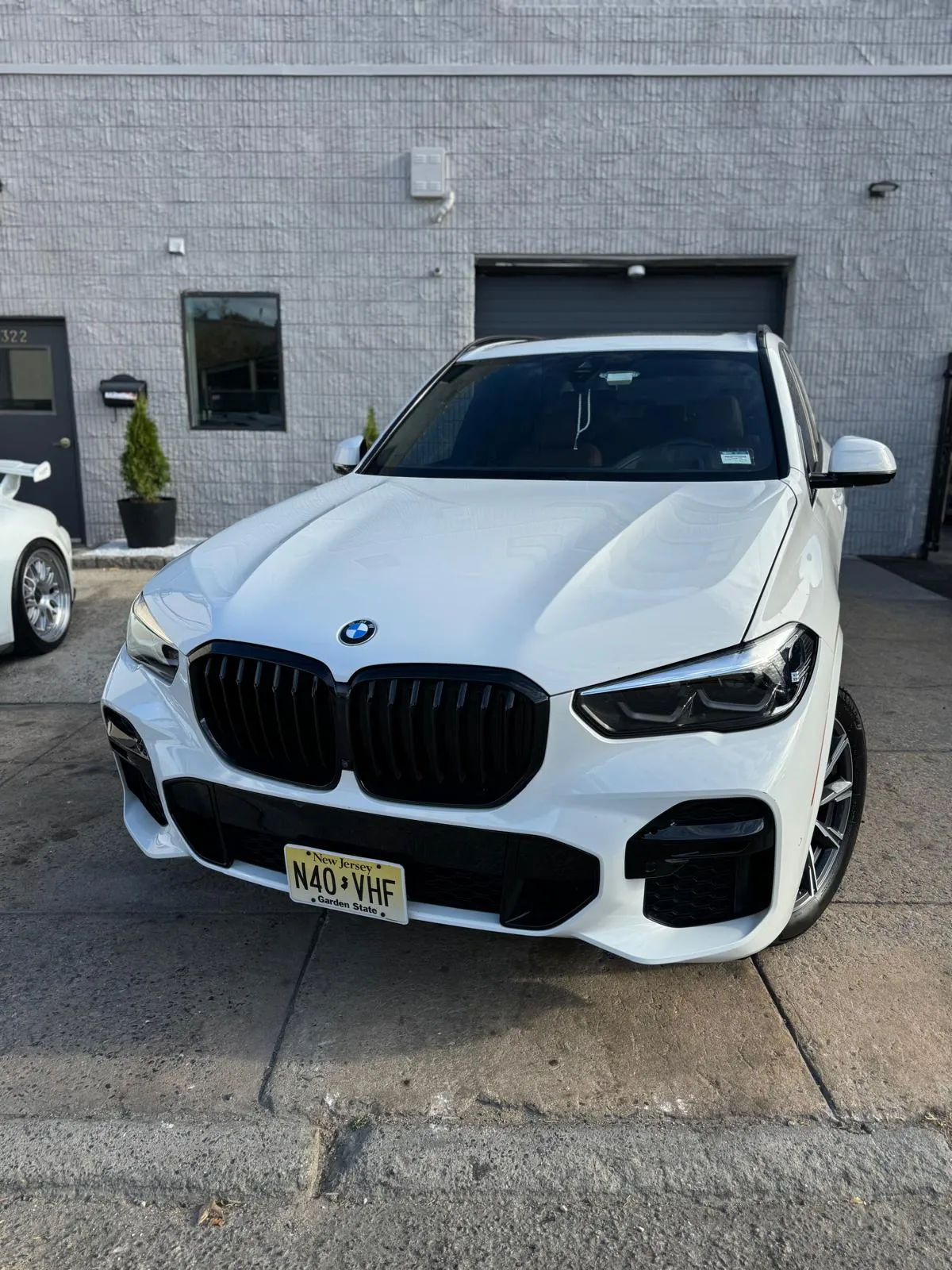 White BMW X5 M after completed front-end collision repair