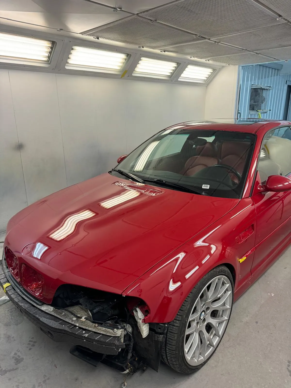 Complete front-end disassembly and refinish in the paint booth. Imola Red color-matched to factory spec.