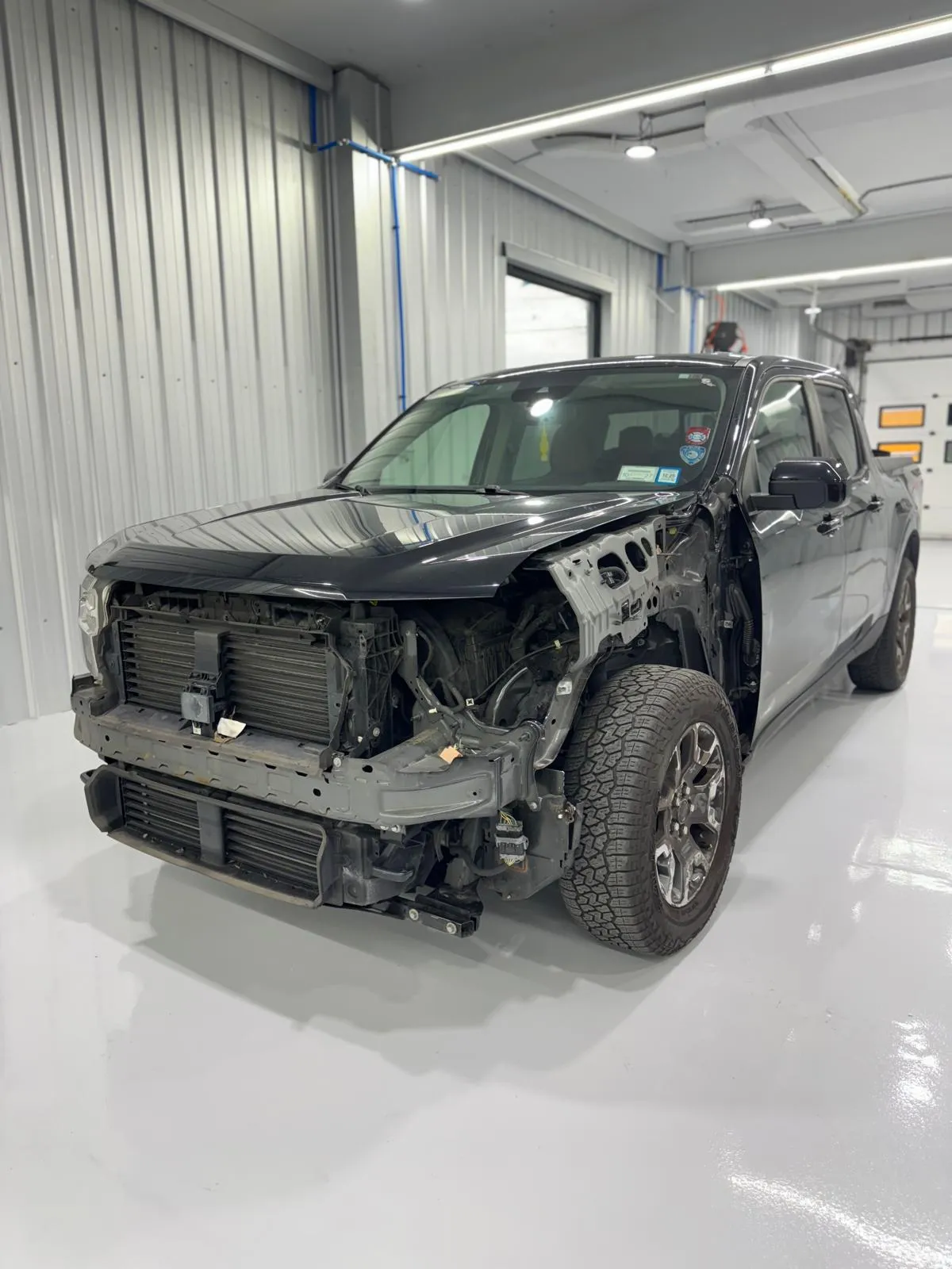 Full front-end disassembly on a truck collision. Structural, mechanical, and body repair.