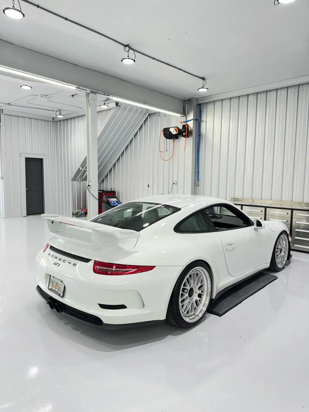 White 991 GT3 rear three-quarter view showing factory wing and custom mesh wheels.