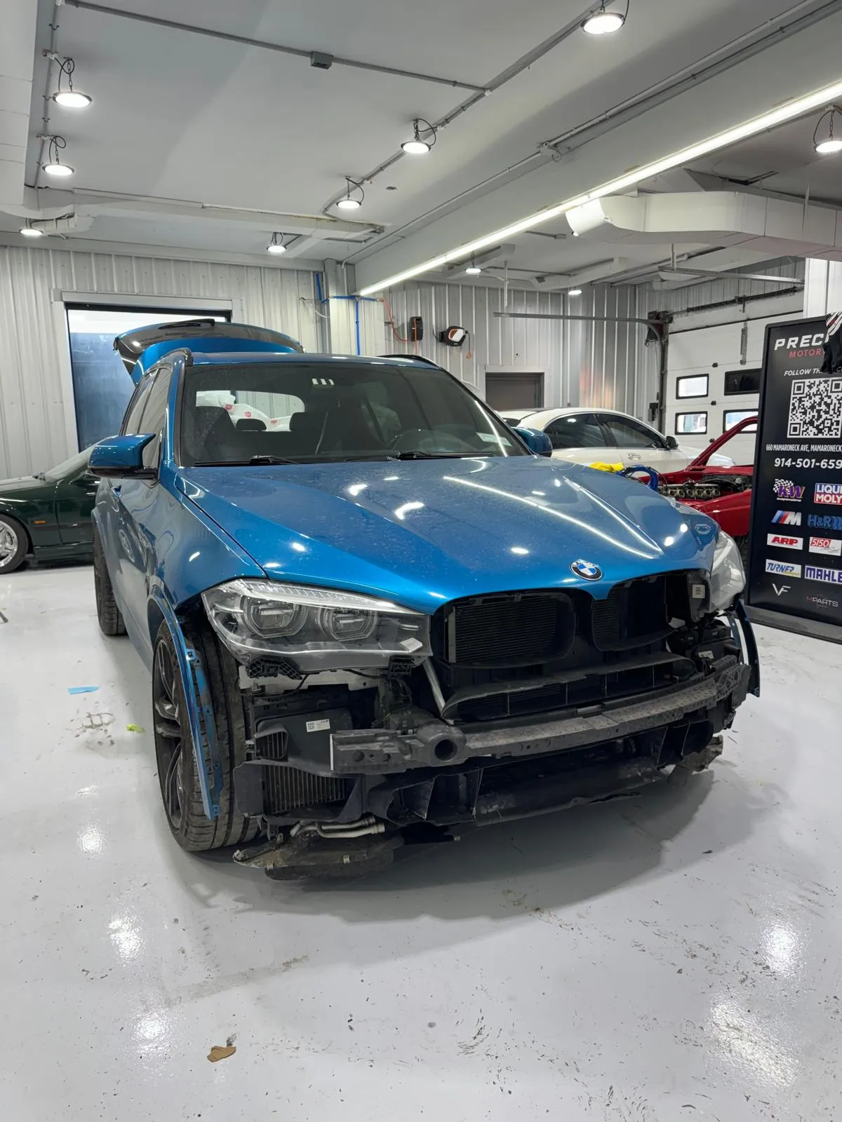 Full front-end disassembly after collision. Bumper, grille, and structural components replaced.