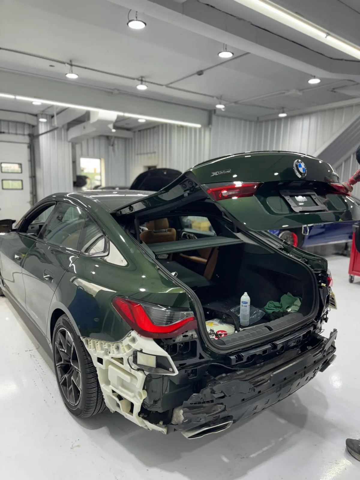 Dark green M440i Gran Coupe rear bumper and trunk lid replacement. OEM parts and color match.